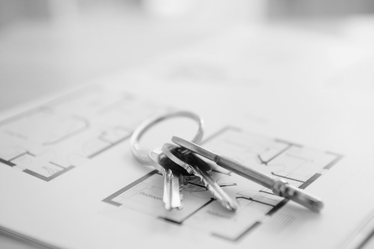 Black and White Photo of house keys on property floor plans